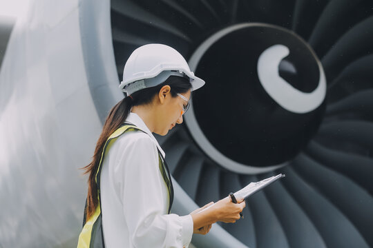 Technician fixing the engine of the airplane,Female aerospace engineering checking aircraft engines,Asian mechanic maintenance inspects plane engine