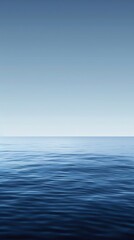 Fototapeta premium Endless blue sea meets clear sky, creating a serene seascape for relaxation and mindfulness. Gradient colors and gentle waves add to the peaceful scene. Perfect for travel or desktop wallpapers