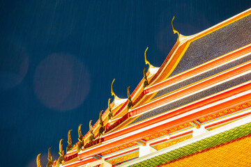 A traditional Asian temple with intricate architecture, featuring a pagoda-style roof and rich...