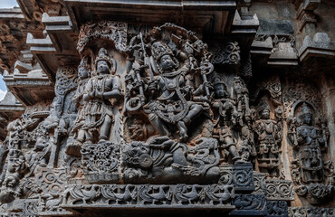 Intricate carvings of Hindu deities and also depict scenes from Hindu epics in the Hindu temple of...