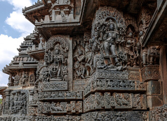 Intricate carvings of Hindu deities and also depict scenes from Hindu epics in the Hindu temple of...