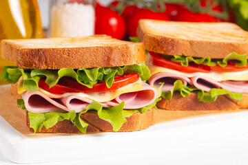 Club sandwich with ham, cheese, tomato and lettuce. 