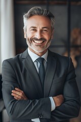 A man in a suit and tie is smiling and posing for a photo. He is confident and happy