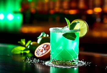 green neon citrus cocktail at bar counter with lights bokeh. fancy alcohol drink at party. Alcoholic beverage. Cocktails tasting.