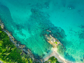 aerial top view above small island in front of Yanui beach in low tide. Sand dunes in the separate sea. Sandbars form in the Separated Sea when the water level goes down. green sea white sand beach.
