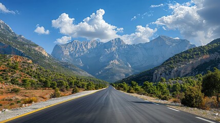 Fototapeta premium Breathtaking view of a winding road surrounded by majestic mountains and vibrant skies, perfect for travel and nature enthusiasts.