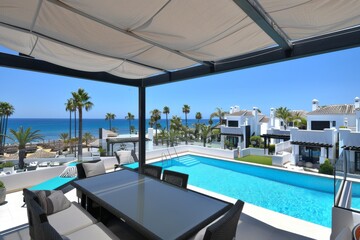 Fototapeta premium Luxurious poolside terrace with modern furniture and ocean view, creating a serene and inviting outdoor retreat.