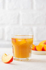 Refreshing peach and nectarine ice tea. Homemade cold summer drink. Vertical orientation.