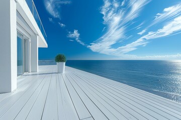 Fototapeta premium Minimalist white terrace with ocean view and clear blue sky, creating a serene and stylish outdoor space.