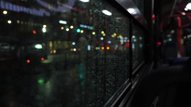 a bus running at night on a rainy day