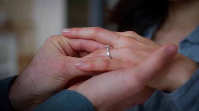 Couple engagement love affection feelings weeding celebration unrecognizable man guy male put ring jewelry diamond on female finger woman girl bride engage future family marry me propose marriage