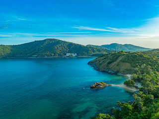 Fototapeta premium Aerial view smooth waves in green sea at Yanui beach.White sandy beaches, green waters, large rocks and pristine forests. .smooth wave after wave crashed onto the shore.