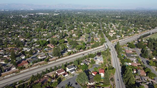 Aerial view of light traffic on Highway 85 cutting through a residential neighborhood near Cox Avenue in Saratoga, California.
