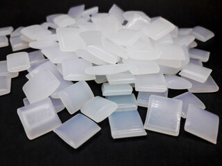 Hot melt adhesive beads on black background