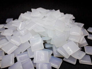 Hot melt adhesive beads on black background
