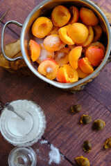 a saucepan with apricots and sugar