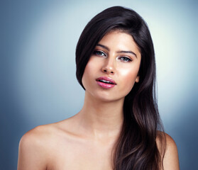 Obraz premium Hair salon, beauty and portrait of woman in studio for haircare, healthy texture and growth. Spa, wellness and person with cosmetics for keratin treatment, grooming and shampoo on blue background