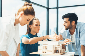 Professional diverse architect engineer team working together to design house model. Group of successful business team discussing and brainstorming about house structure. Civil engineering. Tracery.