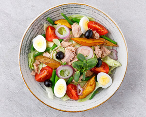 Tuna salad on a gray background. Nicoise salad, for restaurant menu for delivery