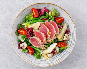 Tuna salad on a gray background. Nicoise salad, for restaurant menu for delivery