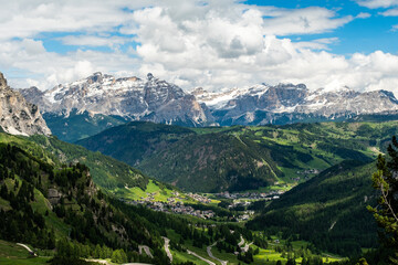 Fototapeta premium Serpentine Road through Gardena Pass: Scenic Route to Colfosco with Majestic Mountains