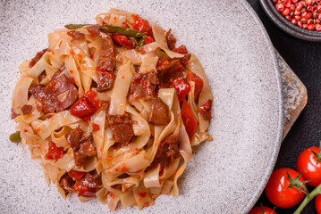 Delicious asian udon dish with vegetables, meat, salt and spices