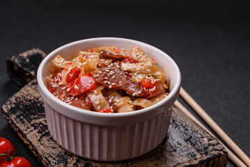 Delicious asian udon dish with vegetables, meat, salt and spices