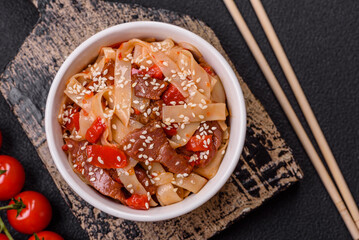 Delicious asian udon dish with vegetables, meat, salt and spices