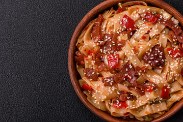 Delicious asian udon dish with vegetables, meat, salt and spices