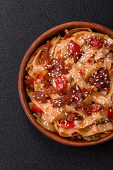 Delicious asian udon dish with vegetables, meat, salt and spices