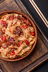 Delicious asian udon dish with vegetables, meat, salt and spices