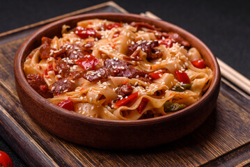 Delicious asian udon dish with vegetables, meat, salt and spices