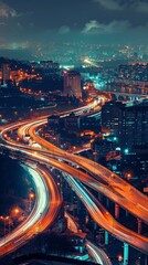 Elevated view of a city at night, showing a complex network of highways and bridges