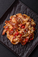 Delicious asian udon dish with vegetables, meat, salt and spices