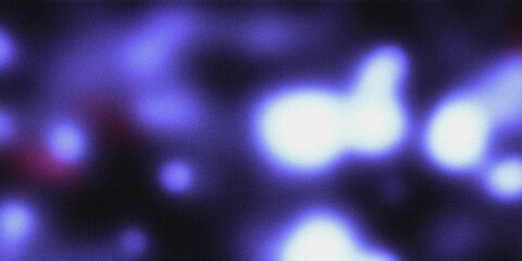 Blurred abstract background with grainy texture in shades of blue and purple