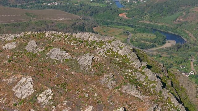 rocky mountain landscape with river in the background on sunny day in Nogueira, Ribas de Sil, Spain