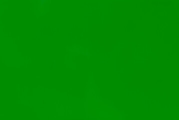 Blurred bright green background of the painted metal surface.