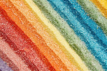Detailed view of multicolored sand stripes with blank area on a light background