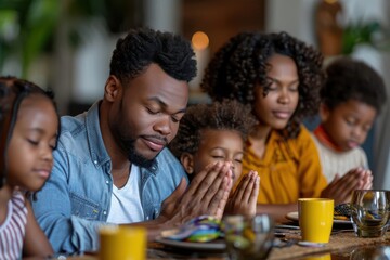 Fototapeta premium Close-up of a family praying together at the dinner table detailed textures and precision