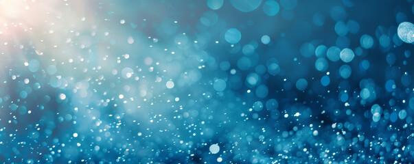 Fototapeta premium A bright blue background with a subtle sparkle effect, adding a touch of glamour and elegance.