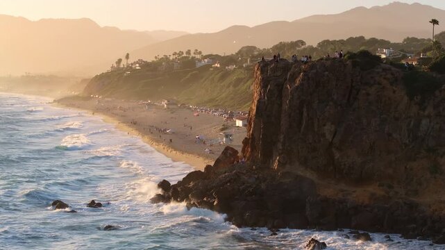 Witness the breathtaking beauty of Malibu, California at sunset with stunning aerial views of cliffs, ocean, and California coast, portraying the essence of this majestic coastline