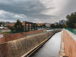 Riverside scene in Wroclaw, Poland, showcasing a mix of historical and modern architecture along the waterfront.