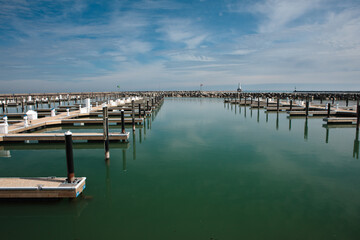 Obraz premium Port Washington, Wisconsin harbor in late winter, after the ice has moved out, on a mid-March sunny morning
