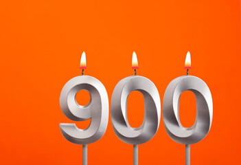 900 candle - Birthday celebration on orange background