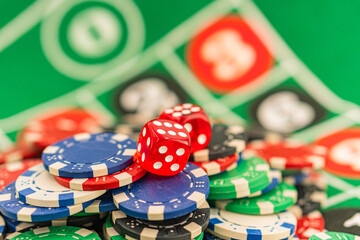 Casino background. Roulette table Chips. Casino theme. High contrast image of casino roulette, poker game, dice game, poker chips on a gaming table