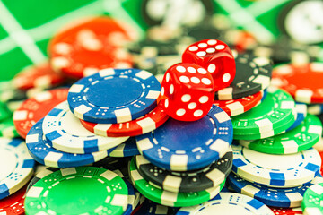 Poker Table With Poker Chips Turns In Casino. Many Poker Chips Spins on the Table in Darkness.