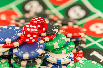 Casino background. Roulette table Chips. Casino theme. High contrast image of casino roulette, poker game, dice game, poker chips on a gaming table
