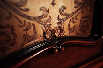 A pair of brown shoes with a silver chain and a white pocket watch. The watch is set at 12:00