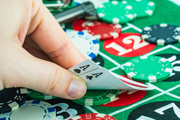 Obraz premium Poker cards with win combination. The player hand holds a winning combination in a game in a poker The concept of luck in the poker game. A winning combination in poker is two aces on a table of chips