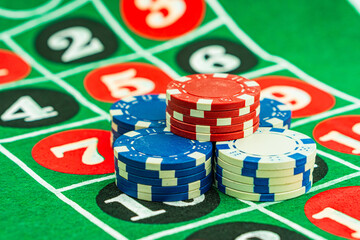 Casino background. Roulette table Chips. Casino theme. High contrast image of casino roulette, poker game, dice game, poker chips on a gaming table